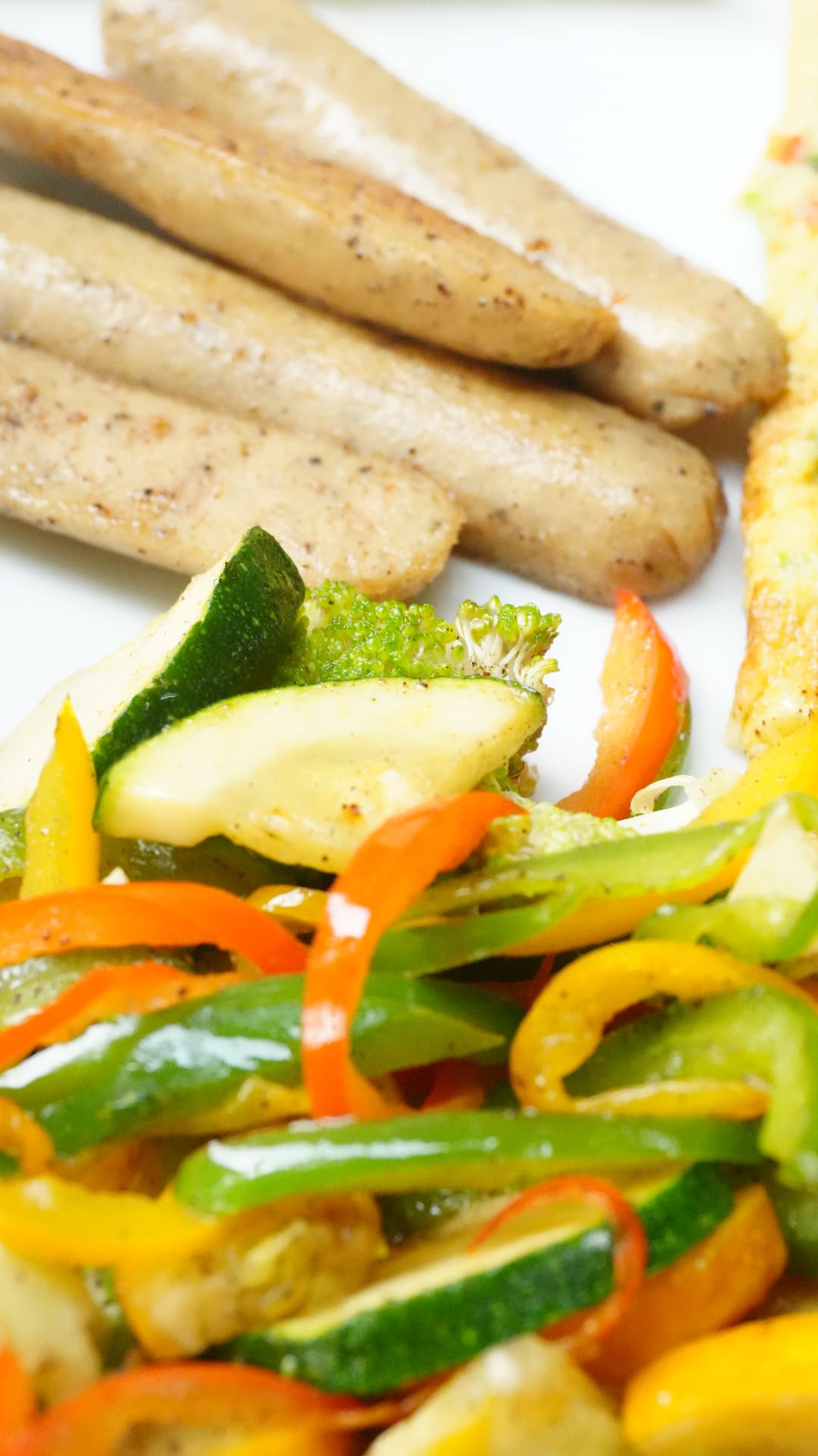 Grilled sausages with sauteed peppers and zucchini